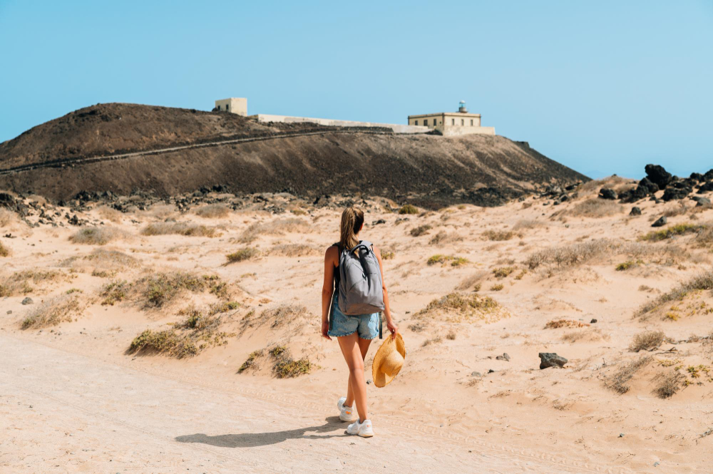 woman-walking-on-road-in-mountains